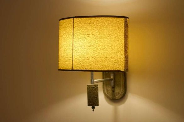 Warm glowing wall lights installed in a dimly lit hallway.